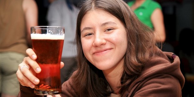girl drinking beer, smiling