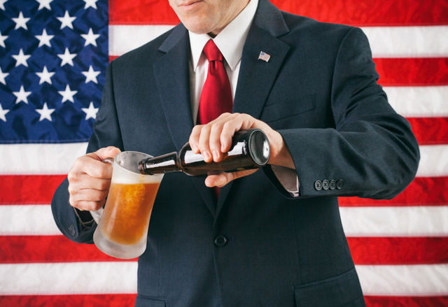 politician pouring beer american flag United States 