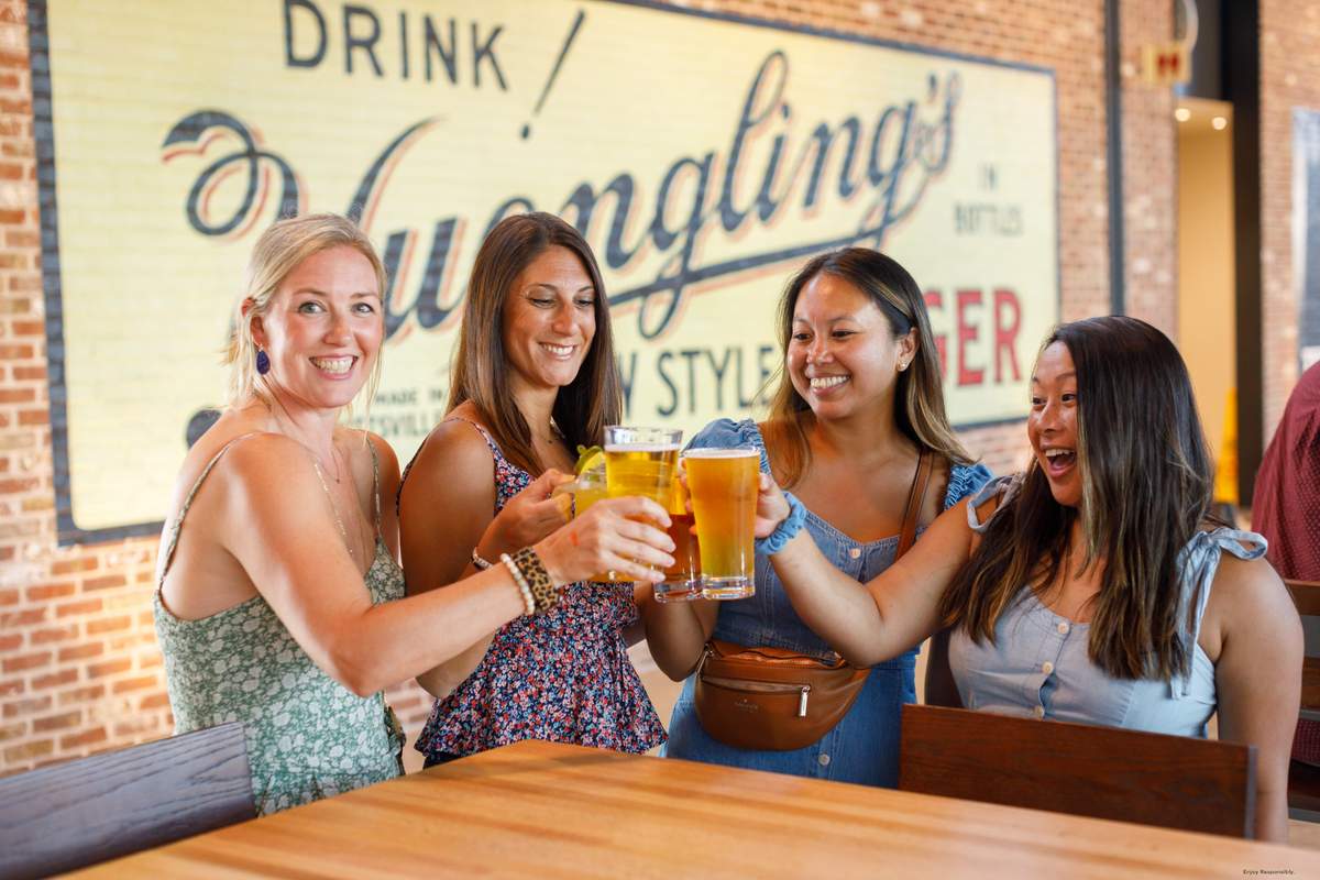 Yuengling Tampa taproom ladies cheering with glasses of beer 
